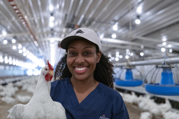 Woman holding white chicken